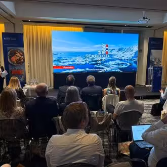 Stage and audience at seafood seminar in Italy.