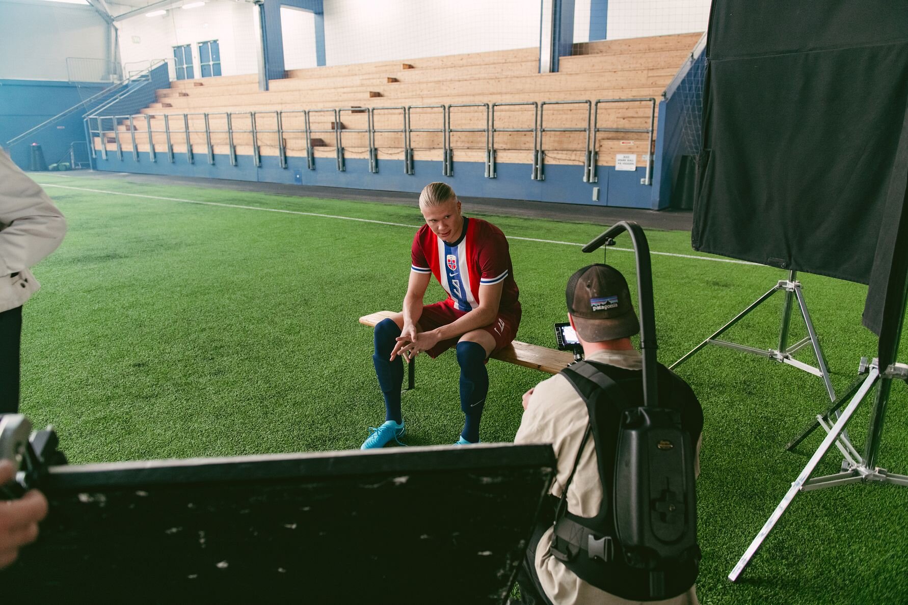 Erling Haaland behind the scenes in the Norwegian Seafood Council’s new videos, football field in the background.