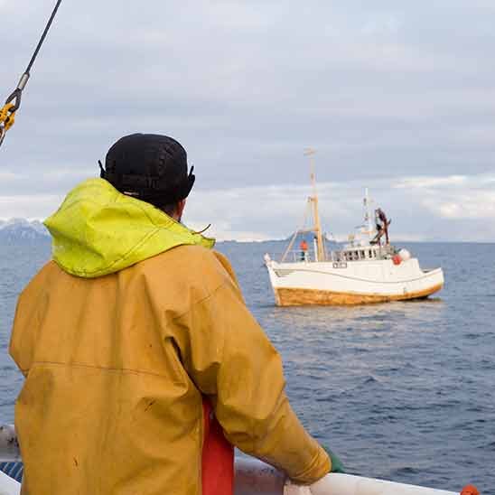 Fisher man and boat on sea