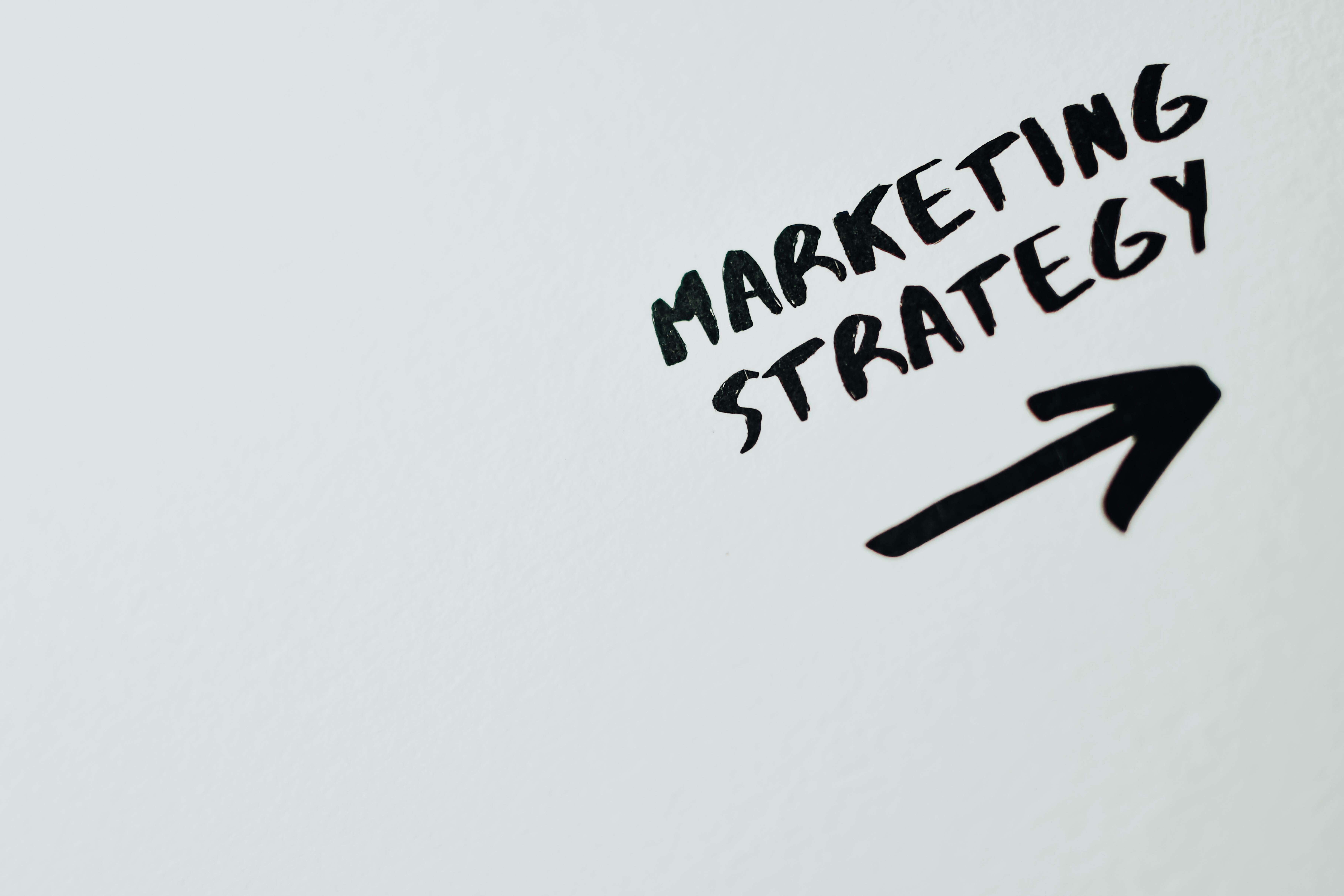 Marketing strategy written in black on white background.