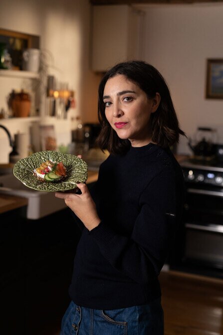 Gaëlle Mancina holding a dish with Norwegian salmon that she has made.