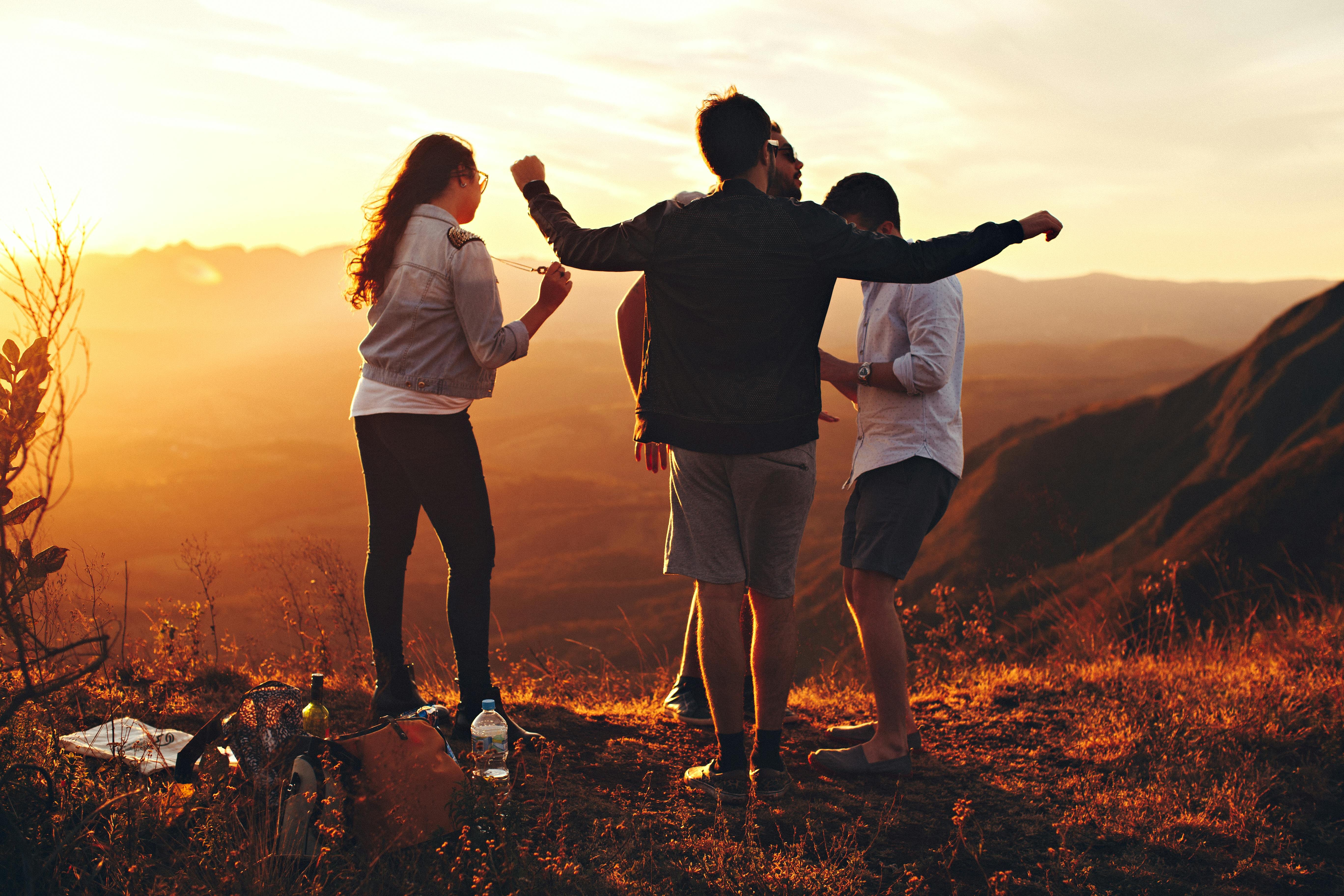 Group of three people outside in sunset