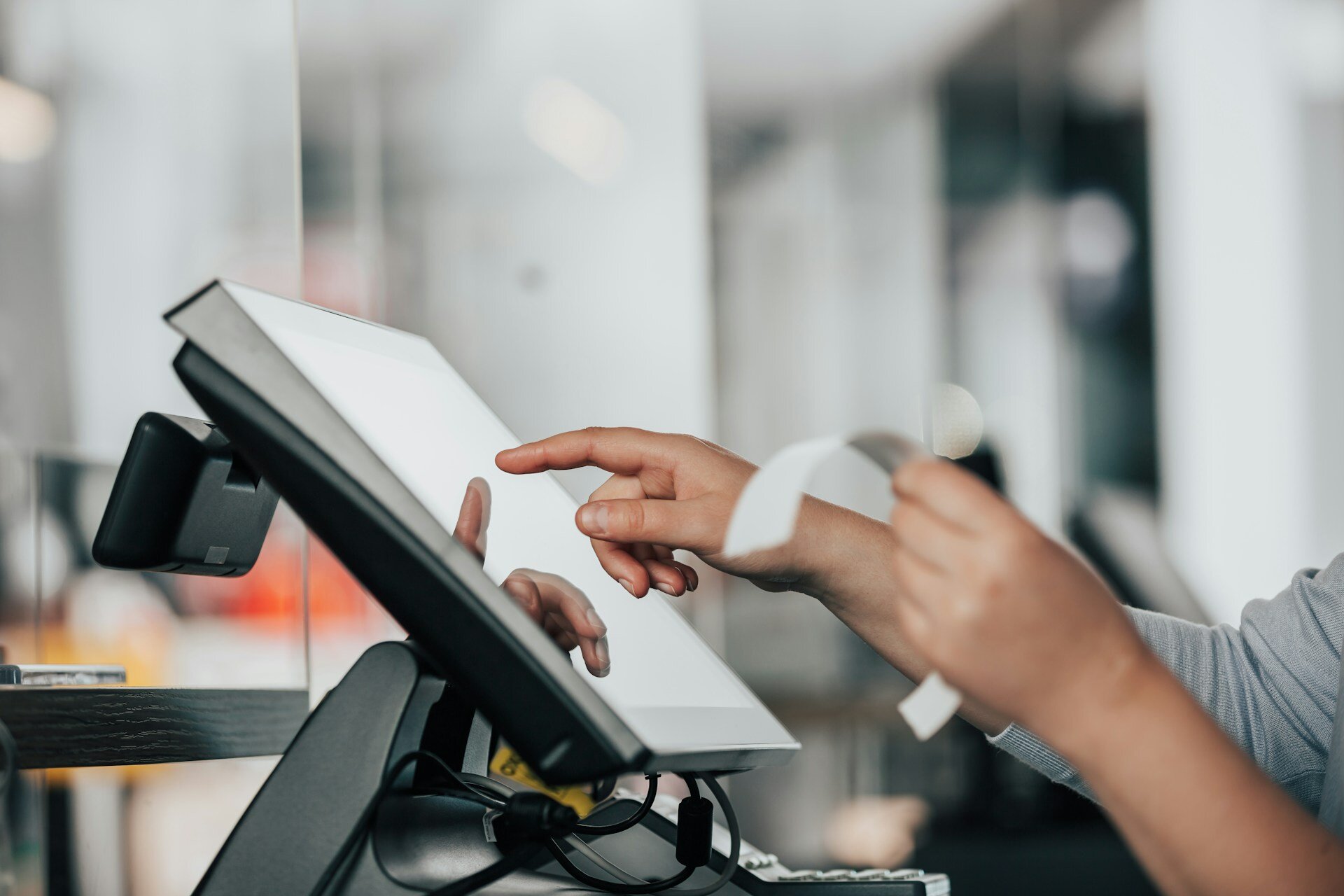 A person is using a pos machine in a store.